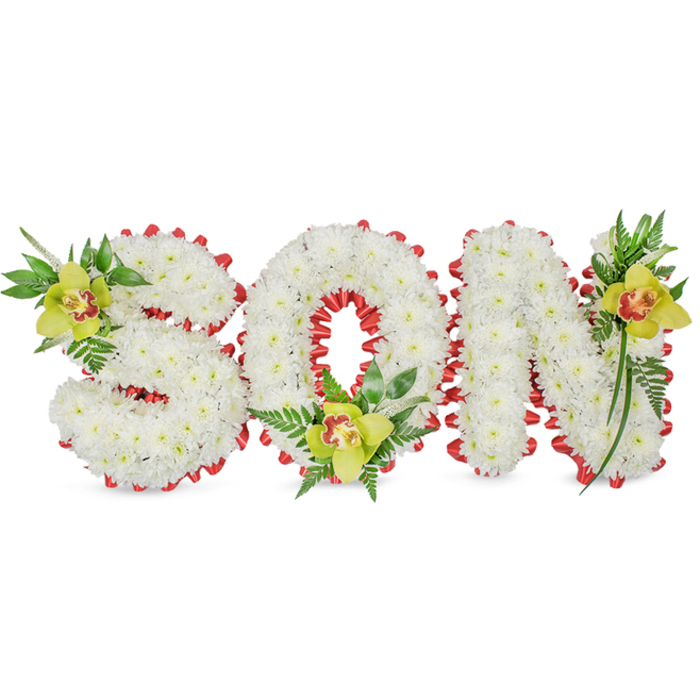 Presented against a clean white background, this refined sympathy piece spells out SON in bold, three-dimensional letters hewn from compact clusters of pure white chrysanthemums. The dense petals form a soft, pillowed surface that absorbs light gently, creating subtle shadows along the contours of each letter and evoking a quiet, reverent mood. A continuous red ribbon is carefully looped around the edges of every letter, folded into small scalloped arcs so the ribbon peeks like a warm heartbeat around the cool white mass; the contrast is deliberate, adding visual clarity and emotional resonance. Anchoring the composition are three lime-green Cymbidium orchids-one on the upper left of the S, one cradled within the hollow of the O, and one accenting the upper right of the N-each orchid showing a pale orange to reddish-brown marking at its throat and surrounded by glossy leaves and delicate fern fronds. These green and bronze-toned centers bring depth and a natural focus point to the arrangement, while the foliage provides a gentle lift and a feeling of renewal. The overall effect is one of careful craftsmanship and heartfelt intention: a personalized memorial suitable for a funeral service, graveside commemoration, or a display of remembrance. As a local florist who delivers across Brent Cross and nearby neighbourhoods such as Hendon Park and Cricklewood, I imagine this tribute placed beside a photograph or on a service table, its restrained palette and tactile textures offering comfort and a meaningful expression of loss and love.