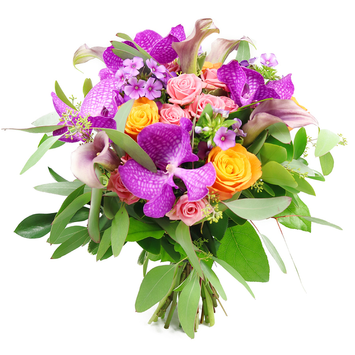 Captured against a bright, uncluttered white background, this exquisite bouquet showcases a rich interplay of colour, texture, and form that feels both luxurious and inviting. Dominating the arrangement are several large Vanda orchids, their petals saturated in intense purple and fuchsia tones and patterned with fine, lighter speckles that give them an almost lace-like complexity. These orchids provide a dramatic focal point, echoed by clusters of glowing orange roses that sit around them like small suns, their tightly rolled petals forming perfect, velvety spirals. Balancing this brightness, soft pastel pink garden roses weave gently between, some still closed as rounded buds, others beginning to open in layered rosettes that suggest tenderness and intimacy. Slender calla lilies emerge with effortless grace in hues of plum, mauve, and soft lavender, their trumpet-shaped blooms curving upward and outward to create elegant lines that guide the eye through the bouquet. Between the larger flowers, fine sprays of lavender and tiny purple filler blossoms add delicate movement and fine-grained texture, like the murmur of background conversation at a celebration. The foliage beneath is lush and varied: long, silvery eucalyptus leaves sweep outward in gentle arcs, while darker, more compact greenery nestles closer in, supporting the blooms and adding depth and contrast. At the base, the fresh stems are clearly visible, bundled together in a neat, hand-tied style that suggests the bouquet has just been finished in a local studio near Brent Cross. This harmonious blend of fuchsia, tangerine, blush pink, and verdant green feels ideal for marking joyous occasions-perhaps a birthday in a family home near the shopping centre, a thank-you delivered to an office in Cricklewood, or a romantic surprise after an evening walk by the Welsh Harp-radiating both sophistication and heartfelt emotion.