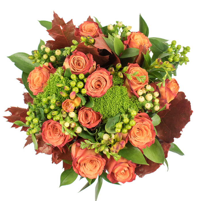 Viewed directly from above on a pristine white surface, this rich autumn bouquet feels like a small harvest laid out for a celebration. The focal point is a generous cluster of fully opened roses, their layers of petals progressing from pale peach and warm coral at the centre to bolder orange and russet tones at the edges; subtle reddish-rust tipping on some outer petals creates a painterly gradient that echoes autumn foliage. Nestled between the roses are compact clusters of Hypericum berries in lively lime-green and soft cream, which provide glossy, bead-like accents and a pleasing contrast of shape and sheen. Dense tufts of Green Trick dianthus - moss-like and vividly green - introduce an unexpected, tactile element that reads almost like cushiony forest floor. A backdrop of fresh deep greens, including broad shiny leaves and smaller textured foliage, gives the arrangement a lush, full-bodied base, while strategically placed lobed leaves in deep burgundy and burnt brown echo fallen leaves and add seasonal drama. The composition is tightly rounded and layered so light skims the rose petals and catches the glossy berries, producing gentle highlights and soft shadows that enhance depth. There's an impression of soft, natural fragrance - rose sweetness mingled with an earthy, green note - making this piece an inviting choice for autumn gatherings, a Thanksgiving centrepiece, or a thoughtful seasonal gift. Handcrafted with the sensibility of a Brent Cross neighbourhood florist, it brings warmth and a sense of harvest-ready abundance to homes near Brent Reservoir and the surrounding streets.