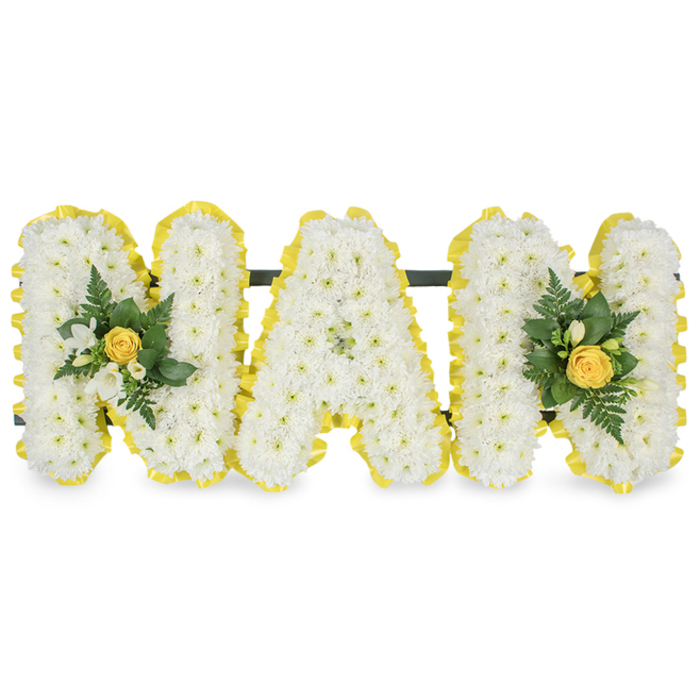 A carefully composed, personalised sympathy piece spells the tender word MAM in three individual capital letters, each densely covered in small white chrysanthemum spray flowers that create a rich, textured surface like folded snow. Every letter's edge is trimmed with a bright yellow satin ribbon, pleated and smooth, which outlines the shapes with a sunlit, optimistic contrast to the pristine whites. Two small bouquets accent the design: one nested on the left upright of the first M, the other mirrored on the right upright of the final M. Each accent is arranged around a neat yellow rosebud - petals tightly wrapped - and accompanied by clusters of tiny white freesia blossoms, slender fern fronds and deep glossy leaves that add verdant shadows and a refined freshness. The letters are connected by a subtle dark green or black horizontal bar across their upper backs, lending stability and allowing the tribute to stand upright on an easel or board at a funeral service. The overall scent is gentle - a whisper of freesia mixed with the soft green perfume of foliage - while the visual impact is quietly uplifting, combining purity and warmth. Crafted with the attention to detail a family expects in Brent Cross, this arrangement suits a memorial near the shopping centre or a graveside service in local churchyards, serving as an intimate, respectful homage that celebrates a mother's gentle warmth and lasting presence. For those arranging locally, Brent Cross Flowers can recreate this design with fresh seasonal blooms.