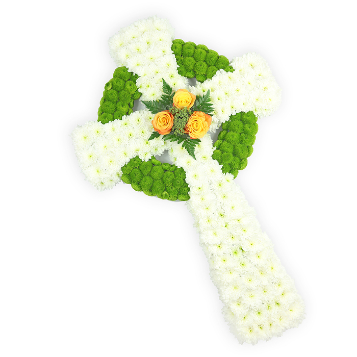 A striking three-dimensional Celtic cross crafted entirely from fresh flowers is presented here against a crisp white studio background, the photo emphasising the piece's sculptural clarity and refined craftsmanship. The foundation is a dense carpet of small, pure white chrysanthemums - each tiny head packed to form the substantial arms and extended lower shaft - lending the cross a plush, cloudlike solidity. Interlaced among that white field are vibrant lime-green button chrysanthemums, tightly arranged to outline the circular ring at the intersection and to create alternating patches along the horizontal arms; these green accents provide a lively, almost chartreuse contrast that defines the Celtic motif with precision. Nestled at the very centre where the arms meet is a compact cluster of three orange-yellow roses, their petals warm and saturated, offering a poignant focal point framed by discrete sprigs of dark green foliage that add depth and a natural counterpoint. The triad of white, vivid green and golden-orange quietly evokes the colours of the Irish flag, making this an especially meaningful tribute for those with Irish roots or Celtic faith traditions. Soft, directional lighting highlights petal texture and the arrangement's three-dimensional form, while the careful wiring and floral mechanics remain discreet, a mark of professional technique. Prepared by Brent Cross Flowers for local memorials and funeral services, this piece is suggested for ceremonies across Brent Cross, Hendon and surrounding neighbourhoods, where it can serve as a dignified emblem of remembrance and cultural esteem; the fresh flowers impart a subtle, comforting scent and a visual stillness that honours memory with grace.