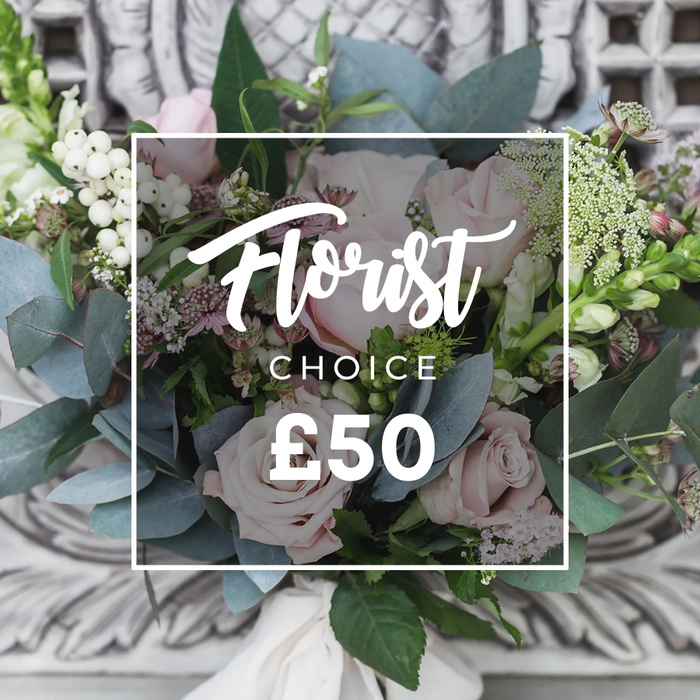 A lush, expertly composed bouquet occupies the frame, its soft blush roses immediately drawing the eye with their layered, velvety petals. Around them, rounded eucalyptus leaves in dusty blue-green provide a cool, silvery counterpoint that soothes the pink tones. Clusters of bright white berries-snowberries or hypericum-are scattered through the arrangement, adding textural contrast and small points of brightness, while fine sprays of tiny white flowers, possibly waxflower or astrantia, lend an airy, natural feel as if the stems had been gathered from an English cutting garden. Hints of deeper pink or burgundy blooms are tucked into the shadows between larger heads to create dimensional warmth, and taller, slender green-and-white flower spikes peek out from both sides, bringing verticality and a subtle sense of movement. The hand-tied stems are finished with a cream fabric ribbon at the base, conveying care and a tactile, gift-ready presentation. The bouquet is set against a softly blurred, ornate carved stone or plaster background that reads as elegant and timeless; overlaid on the image is a clean white frame with pale white lettering that reads 'Florist' in script and 'CHOICE' beneath it, with a clear price shown as '£50', indicating a curated florist's selection. Photographed in gentle natural light, the arrangement radiates calm refinement-perfect as a polished gift for a birthday, a thoughtful congratulations across the Brent Cross area, or as a graceful centerpiece for a quieter celebration. The overall effect is tactile, artful, and quietly luxurious without feeling fussy.