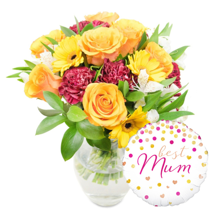 A vivid, thoughtfully composed gift sits against a pure white background: a generous bouquet placed slightly centre-left in a clear glass vase, paired with a round white foil balloon at the lower right. The flowers read warm and celebratory - fully opened roses in rich orange and bright yellow create a luminous core, their velvety petals layered in gentle spirals. Interspersed are bright yellow gerbera daisies with dark centres that pop like mini suns, and deep burgundy carnations whose ruffled, plush petals provide a luxurious, grounding contrast. Sprays of delicate white alstroemeria, marked with faint freckles, add a refined lightness that lifts the palette. Lush green foliage - glossy broad leaves and slender twiggy stems - fills and frames the arrangement, and the clear vase allows a view of the trimmed stems and clear water, underscoring the freshness of the collection. The glossy balloon is festooned with scattered gold and fuchsia confetti dots and tiny heart motifs; across its face the flowing fuchsia script reads best Mum, giving the whole gift an intimate, celebratory voice.
The photograph's soft, even lighting accentuates petal texture and glass reflections with no harsh shadows, and you can almost imagine the gentle scent of roses and greenery. Expertly balanced and hand-finished, this bouquet makes an ideal Mother's Day or birthday surprise for someone special. Brent Cross Flowers arranges similar combinations for same-day delivery across Brent Cross, Hendon and Golders Green, often chosen by customers shopping at the nearby Brent Cross shopping centre or travelling along the North Circular.