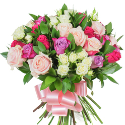 Set against a brilliant white field, this lush bouquet of mixed roses feels like a private garden gathered into a compact, joyful arrangement. The composition is dominated by large, fully opened roses in muted pastel pink and creamy white-petals layered like silk and catching the light in smooth, satiny waves-while deeper magenta or fuchsia roses breathe warmth and a bold romantic pulse into the cluster. Soft lavender roses are placed with restraint, their cool hues offering a whisper of contrast that deepens the overall palette. Nestled in the hollows between these statement blooms are sprays of small white roses with gentle yellow hints at their throats, lending delicate texture and a lively, dotted rhythm across the bouquet. Glossy, deep green leaves-probably ruscus or salal-provide a lush backdrop, their firm, lance-shaped blades slipping through the flowers and giving the arrangement structure and a sense of freshness. The stems are neatly gathered and secured with a broad, pale pink satin ribbon tied into a flowing bow, the ribbon's sheen echoing the petals' soft lustre and grounding the bouquet with an elegant finish. Under soft studio light the colours feel immediate and tender, and the imagined scent is modestly rosy with a crisp green lift. Crafted with care, this bouquet speaks of affection and celebration-perfect for anniversaries, Mother's Day, or a warm birthday greeting-and is an ideal choice for delivery across Brent Cross, Cricklewood and the surrounding neighbourhoods.