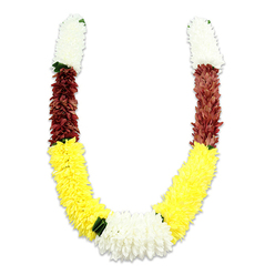 There is a quiet, ceremonial rhythm in this U-shaped floral mala, captured against a stark white field that highlights the craftsmanship and colour story. Made from densely layered synthetic petals, the garland feels substantial yet softly articulated, as if each tiny fabric bloom were stitched to hold a memory. The top of each arm begins with a tightly packed cylinder of pristine white flowers - small, chrysanthemum-like forms whose delicate contours suggest purity and calm. Below these, a compact band of deep maroon or reddish-brown fibers introduces an earthy, reverent counterpoint; its warmth anchors the design and enriches the palette. The garland then unfolds into long runs of vivid yellow, the dominant visual language of the piece, creating a broad, uplifting curve that reads as celebration and welcome. At the lowest point a lavish cluster of white blooms joins the two arms, a luminous centrepiece softly set off by tiny dark-green leaf accents that delineate the colour transitions and give a natural contrast. Under soft directional light, shadows fall subtly between petals, revealing the textural detail of thousands of tiny fabric elements arranged with patient skill. The result is both decorative and devotional - a versatile piece for temple offerings, wedding rituals, or festival displays. Imagining it draped at a home altar in the Brent Cross neighbourhood or carried during procession evokes warmth and reverence; the fabric construction promises longevity and repeated use for rites and gatherings across nearby Hendon and Golders Green.