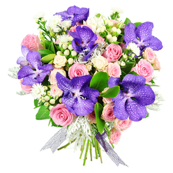 This elegant bouquet is photographed on a clean white backdrop, highlighting its sophisticated interplay of hues and textures. At its core, several large Vanda orchids draw immediate attention with their velvety petals in shades of rich violet and inky blue, each flower decorated with fine, irregular speckles that create a dramatic, almost cosmic pattern. These striking orchids are spaced throughout the design so they crown the bouquet like jewels. Cradling them is a lush bed of roses: soft pink roses, some still tightly wrapped, others fully open, sit alongside creamy white spray roses that form delicate clusters, filling the arrangement with romantic volume. Nestled between the larger blooms are dainty white filler flowers and clean, rounded hypericum berries in white or pale cream, their smooth surfaces providing a tactile contrast to the layered petals. The foliage plays a crucial supporting role; broad, glossy dark green leaves lend structure and a sense of vitality, while feathery, silver-grey dusty miller leaves soften the overall silhouette with their matte, velvety texture. The stems are bound together at the base with a gossamer ribbon in a silver-lilac tone, sheer enough to let the natural green of the stems peek through while still adding a polished, celebratory finish. This bouquet feels poised and thoughtful, the kind of design Brent Cross Flowers might create for a milestone birthday in a Finchley Road townhouse, an anniversary dinner near Brent Cross underground, or a heartfelt thank-you delivered to offices by the North Circular. Its balance of exotic orchids and classic roses evokes both glamour and tenderness, making it suitable for many cherished life moments.