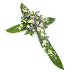I arranged this floral cross to offer a gentle, reassuring presence for moments of farewell, photographed on a plain white ground from a soft overhead perspective to highlight its balanced form. The foundation is a bed of wide, luminous green leaves - think Ti or similar tropical foliage - their glossy planes and pronounced veins forming the clear silhouette of a Christian cross with steady, composed lines. At the centre and radiating along each arm are clusters of creamy ivory and pure white lisianthus, their multi-layered petals unfolding with a refined, almost whispering grace, paired with small white, daisy-like chrysanthemums that bring a crisp, tender brightness. Intermingled within these are sprays of delicate lavender-hued limonium or tiny asters, providing gentle contrast and an airy, meadow-like feel that tempers the solemnity with subtle uplift. Small wisps of fine green filler foliage thread through the blooms, adding softness and depth so the arrangement reads as both crafted and organic. The overall scent is faintly green and floral, the texture a calming interplay between smooth, waxy leaves and soft, ruffled petals. This design is well-suited to funeral services, memorials, or church ceremonies across Brent Cross, Clitterhouse and the surrounding neighbourhoods, and as a local florist I note it travels with the same careful handling and respect expected for such services. For families in the area, Brent Cross Flowers can prepare similar crosses with the same attention to proportion and colour harmony for same-day or scheduled delivery.