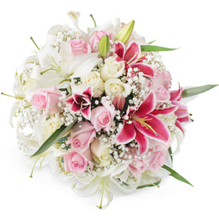 Photographed against a clean, white background, this lush, dome-shaped bouquet appears full and abundant, as though it has just been finished on the bench of a busy Brent Cross florist before heading out for local delivery. The arrangement centres around generous white lilies, with trumpet-shaped blooms that arc open gracefully, each petal smooth and slightly luminous, while a scattering of green-tipped buds promises more flowers to come. Between these lilies, layers of blush pink roses and soft cream roses form a romantic tapestry, their petals tightly coiled in some places and lavishly unfurled in others, creating a gentle rhythm of curves and shadows. Striking fuchsia Oriental lilies, reminiscent of Stargazer lilies, interrupt the pastel palette with dramatic magenta tones; their petal surfaces are adorned with darker speckles and frame bold yellow stamens that stand proudly at their centres. Cloud-like clusters of white gypsophila nestle in the gaps, adding a fine, airy texture that lightens the whole composition and gives a sense of breathability despite its fullness. Here and there, slips of rich green foliage slide between the blossoms, grounding the design and emphasizing the fresh, garden-like character of the bouquet, much like the greenery that lines nearby parks around Brent Cross and Hendon. The bright, even lighting highlights every nuance of colour and surface, from the satin sheen of lilies to the velvety texture of the roses. Together, these elements create an arrangement that feels perfect for heartfelt occasions in the NW11 and NW4 areas-anniversaries, milestone birthdays, or simply sending affection to someone special living near Brent Cross Shopping Centre.