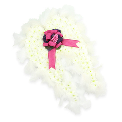 This image captures a serene angel wings floral arrangement, designed as a meaningful funeral tribute and shown against a clean, white background that highlights its purity. The wings are composed of densely packed white chrysanthemums, each tiny flower head aligned in close formation until they resemble a thick, cushioned blanket of cloud. Their crisp white petals, accented by faint green centres, create a soothing, harmonious surface that invites the fingertips, even if only in the imagination. Along the outer contours of the wings, a border of softly layered white feathers forms a delicate halo, blurring the edges and enhancing the impression of light, airy plumage. It is easy to imagine these wings resting quietly in a peaceful chapel near Brent Cross, or beside a coffin during a farewell service. At the centre where the wings meet, a rich fuchsia-pink satin bow brings a vivid burst of colour. The bow is carefully tied, its loops rounded and full, and its long tails trailing gently downward, breaking the expanse of white. Nestled at the bow's heart is a single dusky pink rosebud, tightly furled and flawless, conveying intimacy, remembrance, and heartfelt affection. Directly beneath, a small gathering of deep purple thistle-like flowers or textured foliage introduces drama and contrast, adding depth to the arrangement both visually and emotionally. Together, the white blooms, feathers, pink rose, and purple accents form a tribute that feels both ethereal and grounded, a compassionate symbol of farewell and the enduring connection between families in Brent Cross and the loved ones they mourn.