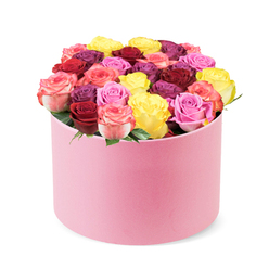 A plush round hat box in a pale pink shade rests before a spotless white studio backdrop, the surface of the container soft and velvet-like, hinting at couture-level care. From the opening, dozens of roses rise in a precisely packed dome, their petals coaxed into perfect silhouettes that speak of meticulous craft. The color story sparkles with joy: bright yellow suns, deep red and burgundy depths, lilac tones, peach creams, and pinks ranging from blush to hot fuchsia, all nestled tightly with minimal greenery to maintain a modern, sculptural line. The overall effect is warm, contemporary, and irresistibly gift-ready, ideal for birthdays, anniversaries, or a romantic gesture that feels timeless and chic.

Faint rose-citrus tones drift from the blooms, a whisper of fragrance that enhances the sense of freshness without overpowering a room. The presentation elevates the bouquet into a keepsake, a stylish centerpiece that would brighten a Brent Cross living room or a doorstep in Cricklewood. For readers seeking reliable delivery, this is a perfect option for same-day service across the Brent Cross area and surrounding NW4 districts, making it easy to brighten someone's day with a note of elegance. The image embodies expertise and passion for floristry, a reminder that big colour can harmonize with quiet luxury when crafted by hands that know their trade.