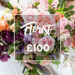A stunning, hand-tied bouquet fills the frame, arranged in a loose, garden-style cascade that feels both luxurious and freshly gathered from a market stall. The dominant tones are soft blush and peach, with several large, velvety pink garden roses taking centre stage; their many ruffled petals fold inward like a silk rosette and suggest a gentle, heady fragrance. Interwoven among the roses are deep plum and burgundy hellebore-like florets that add a dramatic, velvety contrast, and delicate sweet peas in pale purple and white with faint striping that lend an airy, romantic movement. Scattered coral and peach ranunculus or similar layered blooms provide warm highlights, while creamy white accent flowers catch the light and bring a sense of quiet refinement. Abundant green foliage-slender trailing vines, soft eucalyptus-like leaves and broader textured greens-forms a fresh, organic backdrop that softens the colour transitions and gives the bouquet its garden-crafted depth. A white rectangular overlay sits centrally over the blooms: the flowing script reads Florist Choice, with CHOICE in smaller uppercase beneath and a bold sans-serif ?100 beneath that, all framed by a thin white square that clearly marks this as a florist-selected premium offering. The bouquet is held gently at the base by a pair of hands, a pale sleeve visible against a softly blurred background, suggesting careful, human handling. Bathed in soft natural light that reveals petal sheen and texture, this arrangement radiates romance and thoughtful luxury-ideal for anniversaries, weddings, or to send a heartfelt message-and is suitable for local delivery across Brent Cross and nearby Hendon.