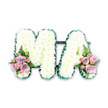 This elegant sympathy tribute presents the letters MA in clear, bold capitals, crafted entirely from flowers to honour a beloved mum, mama, or grandmother. Each letter is densely packed with pristine white chrysanthemums, their multitude of small, rounded petals overlapping to form a deep, cushion-like layer. The uniform white tone brings a sense of purity and stillness, while the rich texture hints at the time and care involved in creating the tribute. Encircling both letters, a deep emerald green satin ribbon is arranged in a fine, ruffled edge, its folds catching the light and giving a subtle shimmer. This pleated border crisply defines the outline of the M and the A, making them stand out clearly. A discreet dark green connector joins the two letters, allowing them to sit together as one coherent design. At the base, small yet expressive floral sprays add a gentle touch of pastel colour. On the lower left of the M and the lower right of the A, clusters of lilac roses, soft pink roses, and miniature pink spray roses nestle together, with some blooms tightly budded and others more open. Delicate fern fronds and fresh green foliage weave through the roses, introducing a natural, airy feel to the composition. Set against a simple white background, the tribute is shown in full detail, with every petal, fold of ribbon, and stem of greenery clearly visible. It feels perfectly suited to a farewell service in Brent Cross, perhaps travelling from a family home near Temple Fortune or Dollis Hill to a local chapel or crematorium, offering a dignified, personal message of love and remembrance.
