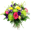 Photographed against a simple white background, this sumptuous, round hand-tied bouquet radiates colour and vitality, as though it has just been selected from a favourite Brent Cross flower shop. At its heart, fully opened hot pink roses dominate, their plush, velvety petals spiralling in richly saturated fuchsia tones that signal romance, joy, and celebration. These are dramatically offset by voluminous lime-green spider chrysanthemums, whose fine, needle-like petals spike outward in all directions, lending the design a dynamic, contemporary feel and an almost neon chartreuse glow. Interlaced among them, deep indigo and royal purple lisianthus blooms, both open and in bud, add cool, moody tones and a softly ruffled texture that balances the bold pinks and greens. Scattered bright yellow gerbera-style daisies introduce playful warmth, their sunny discs and neatly arranged petals catching the light like little bursts of happiness. A single pale cream-to-soft-yellow rosebud, tightly composed, offers a quieter, more intimate note. Smaller filler flowers in light pink, lavender, and periwinkle peek out from between the larger blooms, their tiny petals and slender buds introducing fine detail and a touch of wildflower charm. The entire bouquet is cradled in abundant greenery: glossy dark green leaves, rounded eucalyptus-like sprigs, and airy fern fronds that spill gently around the edges, giving depth, structure, and a sense of freshness. Neatly gathered stems at the base reveal the bouquet's hand-tied craftsmanship, suggesting it is ready for same-day delivery to homes and offices throughout Brent Cross. The overall impression is of an uplifting, thoughtfully curated arrangement, ideal for marking milestones, sending heartfelt congratulations, or simply adding a vivid splash of colour to an otherwise ordinary day.