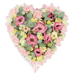 Set against a bright, uncluttered white background, this heart-shaped floral arrangement appears as a gentle, pastel emblem of remembrance. The heart's shape is carefully defined by a dense ring of pale pink carnations, their gently ruffled petals creating a soft, quilted border that seems to cradle the flowers within. Following this outer line, a soft pink satin ribbon nestles among the blooms, glinting subtly as it curves around the heart before tying into small, neat bows at the upper and lower points. Inside, the heart is abundantly filled with a harmonious mix of blooms. Open lisianthus flowers in shades of rich pink and rose sit prominently, their velvety petals curling back in layers that add texture and a sense of loving care. Interspersed around them are clusters of creamy yellow and ivory spray roses or smaller lisianthus, bringing a warm, gentle glow to the design. Tiny white daisy-like flowers with golden yellow centres are dotted among the larger blooms, hinting at the charm of simple garden flowers and softening the composition. Rounded sprigs of silvery-green eucalyptus weave through the flowers, their cool tones and distinctive shapes offering a calming balance, while deeper green and variegated foliage provides subtle shadows and depth. The overall effect is serene, tender, and quietly elegant, an arrangement ideal for funerals, memorials, or celebration-of-life services in and around Brent Cross, Cricklewood, or nearby synagogues and chapels. It feels like a floral embrace, a considered tribute that gently conveys sympathy, cherished memories, and lasting love.