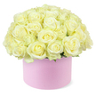 A sophisticated hat box arrangement of roses fills the scene, its style perfectly suited to the modern, elegant tastes often seen around Brent Cross. The bouquet forms a rounded dome of dozens of roses in soft cream and pale ivory, packed so closely that they appear like a single, plush mound of petals. Each rose is fresh and full, its velvety petals spiralling outwards in layered curls that catch the soft light and create gentle shadows. At the centres, hints of pastel yellow glow subtly, lending warmth and a feeling of early morning sunlight captured within each bloom. Here and there, tiny fragments of green foliage can be glimpsed beneath the mass of roses, providing a restrained yet essential touch of natural contrast. The flowers emerge from a cylindrical hat box in a delicate pastel pink, with a smooth, matte surface that suggests fine, high-quality paperboard chosen with care. The box's simple, rounded shape and understated colour provide a graceful foundation, allowing the creamy roses above to command attention. Set against a pure white background, with no additional props or distractions, the arrangement looks almost as if it is floating in space, its refined form and gentle tones all the more striking. The lighting is soft and even, highlighting the freshness and texture of each petal. This image conjures the feeling of a carefully prepared anniversary gift from Brent Cross Flowers, ready to be delivered to a stylish apartment near the shopping centre, a quiet street toward Hendon, or a family home near Golders Green. It speaks of romance, celebration, and thoughtfulness-a contemporary classic in hat box floral design.