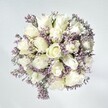 Effortless grace defines this bouquet, its tranquil composition echoing quiet mornings throughout Brent Cross. Plush white roses unfurl at the centre, petals layered in soft, creamy spirals-each one a symbol of fresh starts and thoughtful confidences. Laced among them, pale lavender statice adds a fine, lace-like detail, each miniature bloom enhancing the roses' luminous purity. The bouquet's white-washed background intensifies the sense of freshness, while gentle, natural light plays across every surface, rendering the petals almost velvety to the mind's eye. Subtle touches of green foliage suggest connections to local parks and gardens, grounding the arrangement's airy elegance. Whether intended as a gesture of compassion, a serene celebration, or a simple brightening for a home along Highfield Avenue, this arrangement brings together local expertise and a deep appreciation of floral beauty-an offering from Brent Cross Flowers designed to linger in both space and memory.