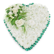 A classic heart-shaped funeral heart is presented on a pure white background, its simple palette of white and green creating a sense of calm and reverence suitable for services around Brent Cross. The body of the heart is composed entirely of small white chrysanthemums, tightly grouped so that they form a thick, even cushion of petals. This dense blanket has a soft, quilt-like texture that feels both comforting and respectful, and the flowers' clean white colour evokes purity, remembrance, and quiet reflection. Along the outside edge, an emerald green satin ribbon has been meticulously pleated and ruffled to trace the heart's outline. Its scalloped profile and gentle sheen provide a graceful contrast against the matte chrysanthemum heads, framing the tribute in a way that is both traditional and elegant-an aesthetic often appreciated at local chapels and crematoria serving the Brent Cross community. At the upper left side of the heart, a decorative floral cluster introduces a focal point. Two fully opened, creamy white roses nestle at the centre, their layered petals soft and velvety. Surrounding them, delicate white blossoms, possibly freesias or similar airy flowers, add fine detail and a lighter texture, with a few buds suggesting blooms still to open. Weaving through this cluster is varied greenery: broad, glossy leaves provide structure, while light, feathery fronds arc gracefully, some trailing over the white chrysanthemum cushion. These touches of green add depth and a natural, garden-like feel to the arrangement. The overall design is poised and thoughtful, a heart-shaped tribute that gently conveys love, sympathy, and support to grieving families in Brent Cross, whether placed beside a casket, at the front of a service, or at a graveside farewell.