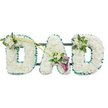 A stately funeral floral tribute forms the word DAD in three freestanding letters, standing out crisply against a bright white background. Each letter is entirely composed of densely packed white chrysanthemums, their compact, rounded heads arranged so closely together that they create a smooth, cushion-like surface. The effect is that of a soft, continuous layer of white, symbolising purity, remembrance, and a calm, respectful farewell. A vibrant emerald green satin ribbon runs around the outside of every letter, gently ruffled to give movement and depth. This ribbon creates a clear outline and adds a rich, natural contrast to the white blooms, making the word easily legible when displayed at a funeral or memorial in Brent Cross, whether near the busy shopping centre or in quieter residential streets of Hendon and Cricklewood. Faint glimpses of a dark supporting frame behind the letters suggest the piece is designed to stand securely during the service.   

Carefully placed accent flowers add warmth and artistic balance. On the upper left portion of the first D, a modest spray of white freesias and glossy green foliage offers a delicate change of texture and form. From this point, two slim green stems curve diagonally across towards the central A, lending the tribute a sense of movement and connection between the letters. At the end of these stems, near the base of the A, an asymmetric focal spray draws the gaze: two deep purple calla lilies, with their smooth, trumpet-shaped blooms, stand out richly against the sea of white, surrounded by smaller white freesia blossoms and fresh greenery. The last D mirrors the first with a smaller arrangement of white freesia and foliage at its upper right edge. The overall impression is one of personal devotion and quiet dignity, the kind of carefully considered DAD tribute a Brent Cross family might choose to honour their father's life and legacy.