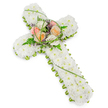 A large floral cross, intended as a sympathy or funeral tribute, is set against a bright, uncluttered white background, allowing its calm beauty to be fully appreciated. The central structure of the cross is completely filled with small white chrysanthemums, each bloom placed closely to the next so that together they form a thick, cushiony layer of petals. This expanse of white conveys a sense of purity, reverence, and peaceful rest. Around the very edge of the cross, a tidy trim of fresh green foliage traces the outline, sharpening the shape and providing a natural frame that recalls the greenery surrounding homes and pathways in the Brent Cross area. At the point where the arms of the cross meet the vertical stem, a focal cluster of larger flowers introduces warmth and subtle colour. Several roses in gentle peach, apricot, and creamy ivory shades open fully, their layered petals lending softness and emotional depth. These roses are surrounded by light, feathery fern fronds and rich green leaves, with thin strands of vivid green grass looping and arching to bring a sense of movement. Scattered among them, tiny purple or lavender filler flowers appear like delicate stitches of colour, enhancing the composition without overwhelming its serenity. The cross is angled slightly in the frame, drawing the viewer's attention to both its length and its centre. This design would be a meaningful gesture for a funeral service, chapel gathering, or graveside visit in and around Brent Cross, offering a graceful expression of faith, condolence, and enduring love.