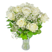 A graceful, carefully arranged bouquet of about twelve pristine white roses and drifting clusters of baby's breath sits in a simple clear glass vase against a bright white backdrop, radiating calm and quiet dignity. Each rose shows soft, creamy petals unfurling outward - some fully open with a gentle cupped centre, others still in the tender stages of opening - their satiny surfaces catching diffused daylight so that the whites range from pure alabaster to the faintest hint of ivory. Interlaced among the larger blooms, countless tiny Gypsophila blossoms form a pale, cloud-like veil that softens edges and lends an ethereal, lace-like texture. Beneath and between the flowers, lush foliage in shades from deep emerald to fresh lime provides structure and contrast, its glossy leaves and tidy stems visible through the transparent vase and the crystal-clear water, a small proof of careful trimming and freshness. The overall composition is meticulously balanced: roundness and height, airiness and solidity, resulting in a bouquet that reads as both celebratory and consoling. The scent is discreet - a tender, green whisper rather than an overpowering perfume - inviting contemplation or quiet conversation in a living room, a ceremony, or an intimate dinner. As a local florist would arrange for a meaningful moment in Brent Cross or nearby Golders Green, this bouquet communicates purity, respect, and enduring affection without fuss. It suits weddings, anniversaries, or those moments when a simple, elegant gesture is more eloquent than words - an honest, beautifully restrained expression of heart and care.