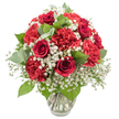 A beautifully composed bouquet of red and white blooms stands in a clear glass vase, photographed against a pure white background that makes every flower appear crisp and vivid, as if it had just been placed on a kitchen table in a Brent Cross home. The focal flowers are deep red roses, each one a swirl of velvety petals wrapped tightly into elegant spirals, suggesting deep affection and timeless romance. Embracing these roses are abundant crimson carnations, their many ruffled petals forming soft, rounded shapes that lend the arrangement a lush, comforting fullness. Threaded through the red flowers is a generous scattering of white baby's breath, its delicate, star-like florets floating between the larger blooms and creating a soft, cloud-like veil that brightens the overall design. Fresh greenery adds subtle structure and contrast, from the darker, slightly glossy rose leaves to circular eucalyptus leaves in cool, silvery-green tones, calling to mind the fresh foliage one might see in gardens and green pockets around Brent Cross and nearby Hendon. The bouquet is carefully arranged into a rounded, dome-like shape, tightly packed yet orderly, conveying the hand and eye of an experienced florist. The simple glass vase, with a slight flare at the lip and a stable base, reveals straight, well-trimmed stems resting in clear water, underscoring the professional care taken in its preparation. Bright, even lighting washes over the scene, enhancing the deep reds, clear whites, and nuanced greens. The mood is intimate, joyful, and slightly festive, making this arrangement perfectly suited for anniversaries, romantic gestures, special family gatherings, or a meaningful surprise delivery to brighten a flat near Brent Cross Shopping Centre or along the North Circular.