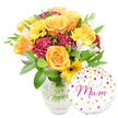 A vibrant, celebratory gift set is arranged against a crisp white background: a lush bouquet sits slightly centre-left in a clear glass vase while a round white foil balloon nestles to the lower right. The bouquet radiates warm, sunlit tones - generous, full-petalled roses in glowing orange and sunny yellow unfurl in soft spirals, their velvety texture catching the light. Bright yellow gerbera daisies punctuate the composition with flat, cheerful faces and dark, almost black centres that contrast beautifully with the roses. Deep maroon carnations, ruffled and plush, add a velveteen depth and sculptural volume between the brighter blooms. Delicate white alstroemeria with slender, speckled petals peek through the mix, lending a refined, airy punctuation that lightens the overall palette. A generous cloud of glossy green foliage - broad leaves and slender sprigs - frames the flowers and creates a lush backdrop, while the clear vase reveals neatly trimmed stems and fresh water, a simple honesty that signals recent, careful preparation.
To the lower right, the glossy round balloon is playfully decorated with scattered gold and hot-pink polka dots and tiny heart motifs; across its face the handwritten-style message best Mum appears in flowing hot-pink script, overlapping the base of the vase in a warm, intimate touch. The lighting is soft and even, emphasizing petal sheen and glass reflections without harsh shadow, and the overall effect is quietly celebratory. You can almost smell the sweet, green fragrance of freshly cut roses and the faint, clean scent of foliage. This arrangement - equally suited for Mother's Day, a birthday, or a thank-you - reflects the same hand-tied care local customers expect around Brent Cross shopping centre and the North Circular, promising a bright, thoughtful gift for a beloved mum.