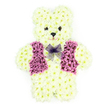 In the photograph, a beautifully detailed floral teddy bear tribute rests against a clean white background, allowing the intricate design to stand out clearly. The bear is sculpted from hundreds of creamy white chrysanthemum heads, packed closely together so the surface appears smooth and velvety, much like the fur of a beloved soft toy. The blooms curve gently around the round head, plump belly, and short little limbs, giving the figure a cuddly, huggable appearance. Its face is expressive yet serene: two small, dark flower centres form bright, button-style eyes, and a slightly smaller dark bloom shapes the nose, with a subtle suggestion of a mouth beneath, creating a look that is tender and reassuring. A waistcoat of rich purple and mauve flowers spans the teddy's chest, carefully arranged to suggest proper panels and neat lapels, as if the bear has been dressed in its best outfit for a special farewell. Around the neck, a lilac mesh bow sits neatly tied, its airy, translucent loops softening the solid, floral form. As a tribute crafted by florists serving Brent Cross, I can imagine this arrangement travelling carefully through local streets near the retail park or along Hendon Way to a quiet service, carrying with it the gentle, green scent of fresh chrysanthemums. The overall effect is one of innocence, warmth, and delicacy. This floral teddy bear is often chosen as a unique funeral or memorial arrangement, especially poignant when remembering a child or someone who brought joy and tenderness, offering a comforting, symbolic embrace of flowers in moments of sorrow and remembrance.